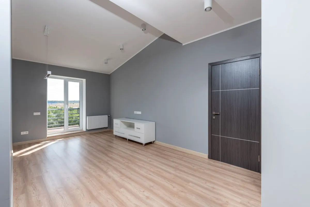 Unfurnished room with grey walls and wooden floor
