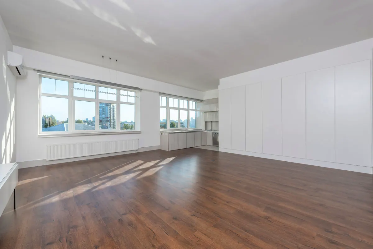 Empty living room with large windows