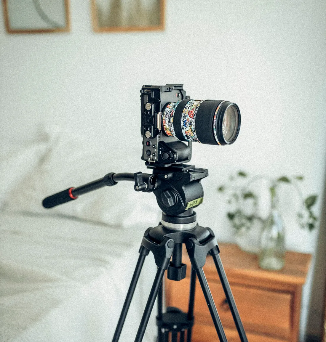 Camera on a tripod set up inside a bedroom